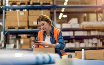 warehouse working using a mobile scanning app on a phone