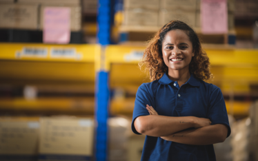 Woman with arms folded in a 3PL warehouse