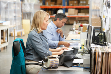 Workers shipping ecommerce orders in a warehouse