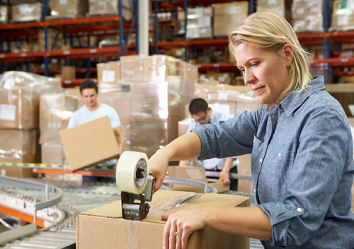 lady in warehouse packing parcel